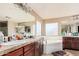 Spacious main bathroom with double vanity, soaking tub, and plenty of counter space at 4725 N 152Nd Dr, Goodyear, AZ 85395