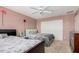 Comfortable bedroom with two beds, carpet flooring, and a built-in closet at 4725 N 152Nd Dr, Goodyear, AZ 85395