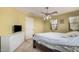 Bright bedroom features a ceiling fan, carpet flooring, and a white dresser at 4725 N 152Nd Dr, Goodyear, AZ 85395