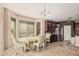 Lovely dining area with a view of the kitchen, complete with a round table and upholstered chairs at 4725 N 152Nd Dr, Goodyear, AZ 85395