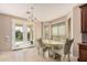 Charming dining area with a round table, upholstered chairs, and French doors leading to the backyard at 4725 N 152Nd Dr, Goodyear, AZ 85395