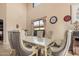 Bright dining room featuring a glass-top table, upholstered chairs, and natural light from a window at 4725 N 152Nd Dr, Goodyear, AZ 85395