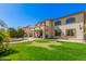 Expansive backyard featuring lush lawn, sparkling pool, and elegant patio with beautiful desert landscaping at 4725 N 152Nd Dr, Goodyear, AZ 85395