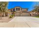 Stunning two-story home featuring a three-car garage and meticulously manicured landscaping at 4725 N 152Nd Dr, Goodyear, AZ 85395