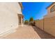 Paver walkway with a glimpse of the pool and lush landscaping; enhancing the backyard appeal at 4725 N 152Nd Dr, Goodyear, AZ 85395