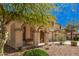 Inviting front porch with cozy seating and a beautifully landscaped front yard at 4725 N 152Nd Dr, Goodyear, AZ 85395