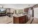 Open concept kitchen and living area featuring tile floors, stainless steel appliances, and great natural light at 4725 N 152Nd Dr, Goodyear, AZ 85395