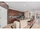 Spacious kitchen featuring dark wood cabinets, a center island, and modern appliances at 4725 N 152Nd Dr, Goodyear, AZ 85395