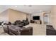 Spacious living room featuring recliner seating, carpet flooring, and access to other rooms at 4725 N 152Nd Dr, Goodyear, AZ 85395