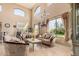 Elegant living room with high ceilings, large windows, and luxurious furnishings at 4725 N 152Nd Dr, Goodyear, AZ 85395