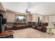 Spacious living room with tile floors, leather sofas, and large windows providing ample natural light at 4725 N 152Nd Dr, Goodyear, AZ 85395