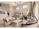 Elegant living room with high ceilings, large windows, and luxurious furnishings at 4725 N 152Nd Dr, Goodyear, AZ 85395