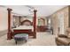Spacious main bedroom featuring a four-poster bed, sitting area, and lots of natural light at 4725 N 152Nd Dr, Goodyear, AZ 85395