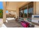 Covered patio area featuring grill, chairs, and outdoor living space at 4725 N 152Nd Dr, Goodyear, AZ 85395
