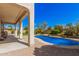 Gorgeous backyard with a sparkling pool, lush landscaping, and covered patio at 4725 N 152Nd Dr, Goodyear, AZ 85395