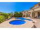 Lush backyard with sparkling pool, spa, and desert landscaping for the ultimate in outdoor living at 4725 N 152Nd Dr, Goodyear, AZ 85395