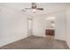 Carpeted main bedroom with neutral color walls, ceiling fan, and bathroom doorway at 4786 E Laurel Ct, Gilbert, AZ 85234