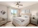 Bright bedroom with ceiling fan, large windows, soft carpet, and modern furnishings at 4803 N Woodmere Fairway -- # 2012, Scottsdale, AZ 85251