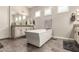 Well-lit bathroom featuring a standalone tub, modern fixtures, and ample counter space at 5114 S Leisure Ct, Gilbert, AZ 85298