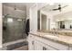 Bright bathroom showcasing a granite vanity with a large mirror and a spacious glass-enclosed shower at 5114 S Leisure Ct, Gilbert, AZ 85298