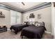 Charming bedroom with two twin beds, shuttered window and decorative accent walls at 5114 S Leisure Ct, Gilbert, AZ 85298