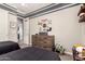 bedroom featuring two twin beds, carpet, a gray accent wall, and dark wood dresser at 5114 S Leisure Ct, Gilbert, AZ 85298