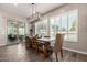 Elegant dining room with natural light, stylish chandelier, and seamless access to the outdoor patio at 5114 S Leisure Ct, Gilbert, AZ 85298