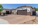 Paver driveway leads to a two-car garage, complemented by mature landscaping and a well-maintained stucco home at 5114 S Leisure Ct, Gilbert, AZ 85298