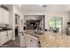 Kitchen island with ample counter space, bar stool seating, and an open view into the living room at 5114 S Leisure Ct, Gilbert, AZ 85298