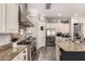 Modern kitchen with a stainless steel range hood, granite counters, and plenty of storage space at 5114 S Leisure Ct, Gilbert, AZ 85298