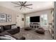Spacious living room with a ceiling fan, media center, comfortable sofa and casual beanbag seating at 5114 S Leisure Ct, Gilbert, AZ 85298