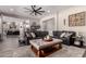 Comfortable living room with a large sectional sofa, stylish ottoman, and neutral color palette at 5114 S Leisure Ct, Gilbert, AZ 85298