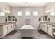 Luxurious bathroom featuring a standalone tub, dual vanities, and modern fixtures at 5114 S Leisure Ct, Gilbert, AZ 85298