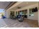 Covered patio with travertine tile and comfortable seating, perfect for outdoor relaxation at 5114 S Leisure Ct, Gilbert, AZ 85298