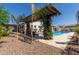 Backyard pool area with lush landscaping and a pergola, perfect for outdoor relaxation at 5114 S Leisure Ct, Gilbert, AZ 85298