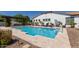Backyard pool with sun shelf, travertine decking, and lounge chairs, perfect for summer days at 5114 S Leisure Ct, Gilbert, AZ 85298