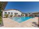 Backyard pool with travertine decking, landscaping, and lounge chairs, creating a relaxing oasis at 5114 S Leisure Ct, Gilbert, AZ 85298