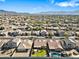 Expansive aerial view showing the neighborhood, local mountains, and the home with a well-manicured backyard and pool at 5318 W Grenadine Rd, Laveen, AZ 85339
