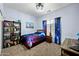 Bedroom featuring carpet, bookshelf, and a window with galaxy-themed curtains at 5318 W Grenadine Rd, Laveen, AZ 85339
