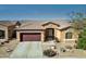Inviting home with manicured landscaping, a spacious driveway, and a charming covered entryway at 5318 W Grenadine Rd, Laveen, AZ 85339