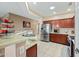 Well-lit kitchen features stainless steel appliances, including a modern refrigerator and beautiful countertops at 5318 W Grenadine Rd, Laveen, AZ 85339