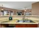 Updated kitchen has stone countertops, stainless steel sink, and views to the backyard at 5318 W Grenadine Rd, Laveen, AZ 85339