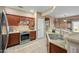 Updated kitchen features tile floors, stainless steel appliances, wood cabinets, and light countertops at 5318 W Grenadine Rd, Laveen, AZ 85339