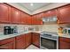 Updated kitchen features a stainless steel range, wood cabinets, and stylish countertops at 5318 W Grenadine Rd, Laveen, AZ 85339