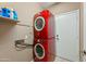 Efficient laundry area features a stacked red washer and dryer unit maximizing space and functionality at 5318 W Grenadine Rd, Laveen, AZ 85339