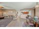 Inviting living room with tile flooring, a comfortable seating arrangement, and an open layout to the kitchen at 5318 W Grenadine Rd, Laveen, AZ 85339