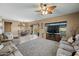 Spacious living room featuring plush seating, a fireplace, and an open dining area at 5318 W Grenadine Rd, Laveen, AZ 85339