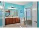 Bright main bathroom with dual sinks, a soaking tub, and a glass-enclosed shower at 5318 W Grenadine Rd, Laveen, AZ 85339