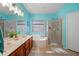 Bright main bathroom with dual sinks, a soaking tub, and a glass-enclosed shower at 5318 W Grenadine Rd, Laveen, AZ 85339