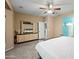 Spacious main bedroom with a ceiling fan and a large dresser and ensuite bathroom at 5318 W Grenadine Rd, Laveen, AZ 85339